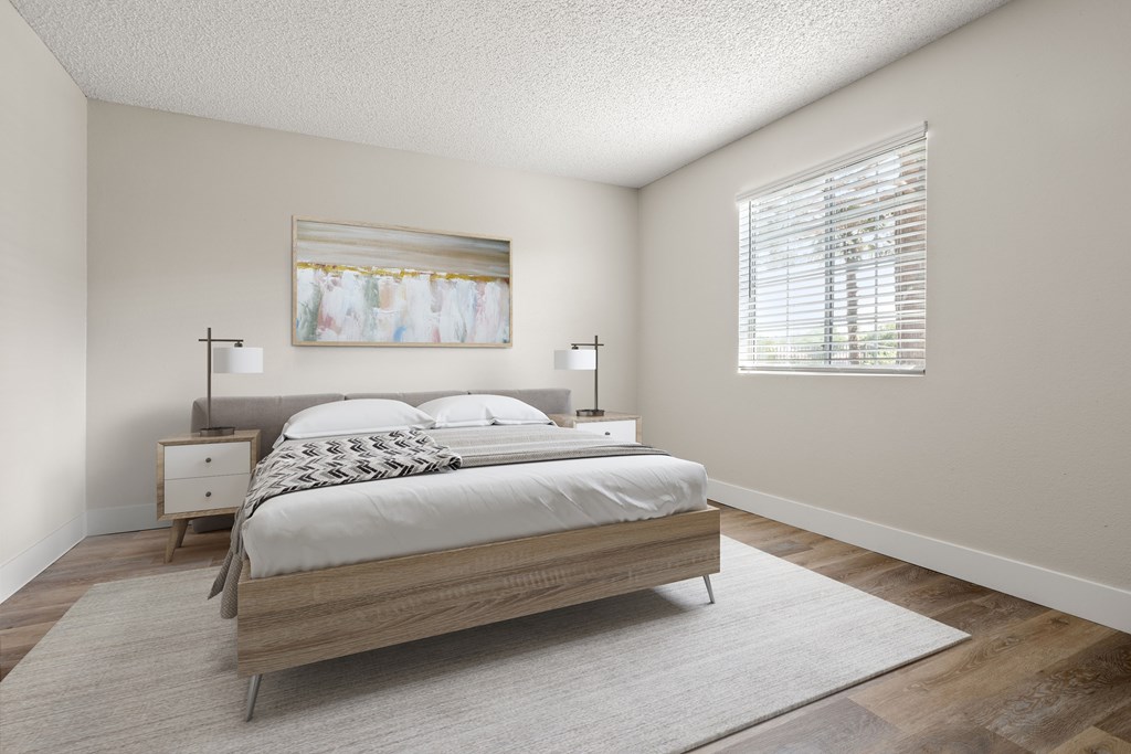 a bedroom with a bed and two nightstands